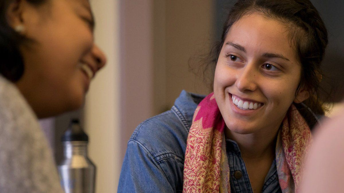 Student Alexa smiles as one of the young women in her d-group shares her story