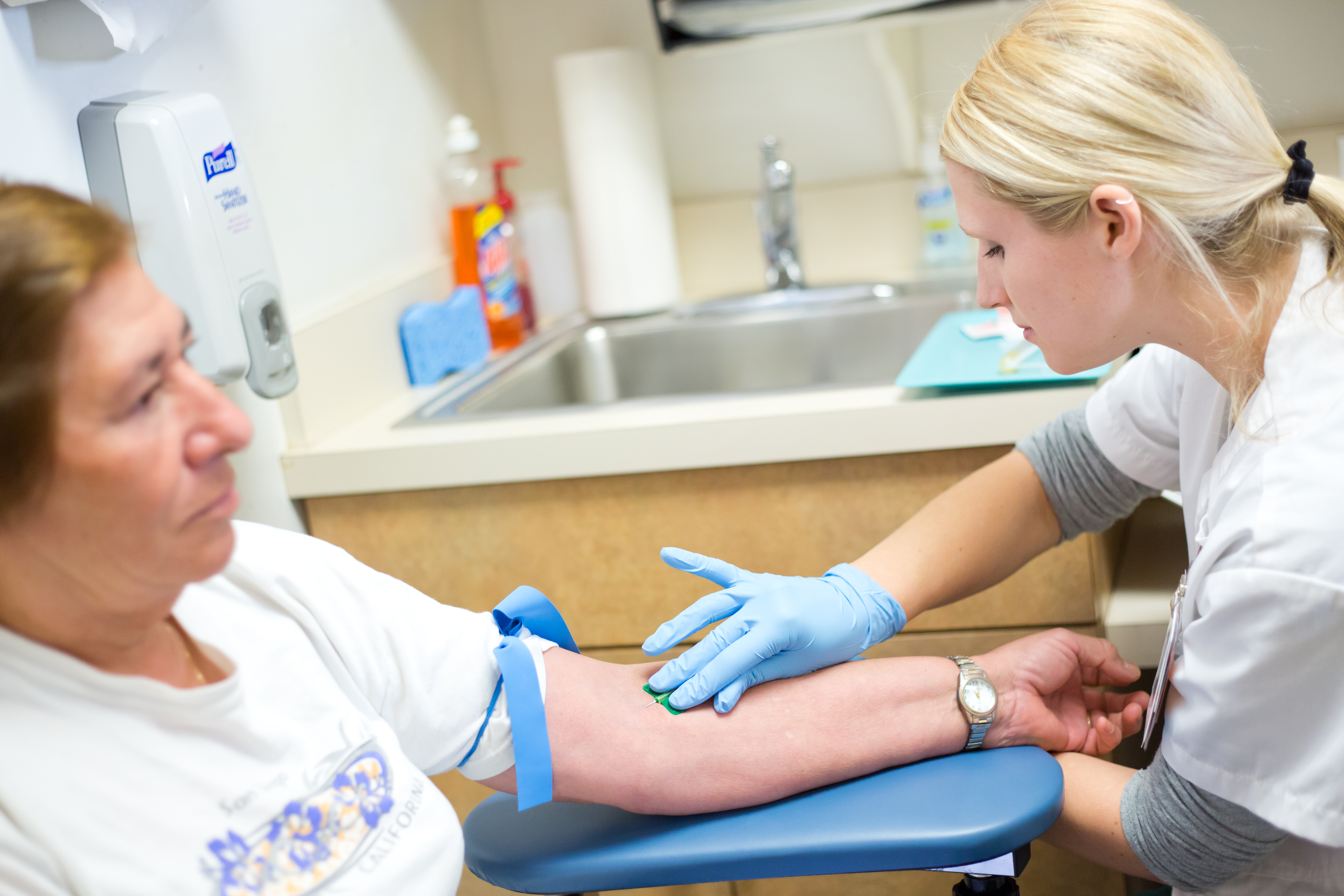 Nurse performs a blood draw on a patient at the HPC