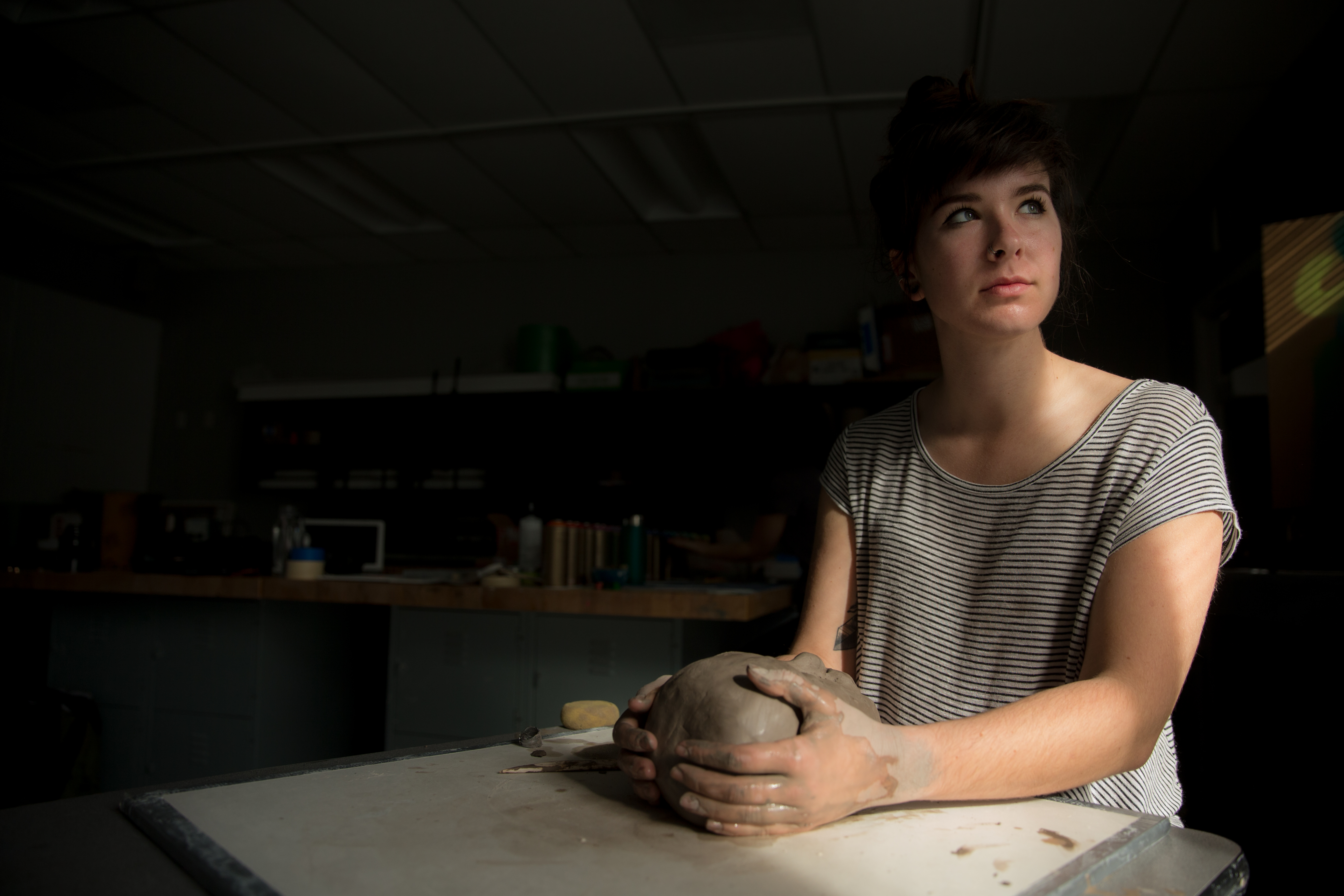 PLNU art student Kelsey Ryan sculpts project in art class.