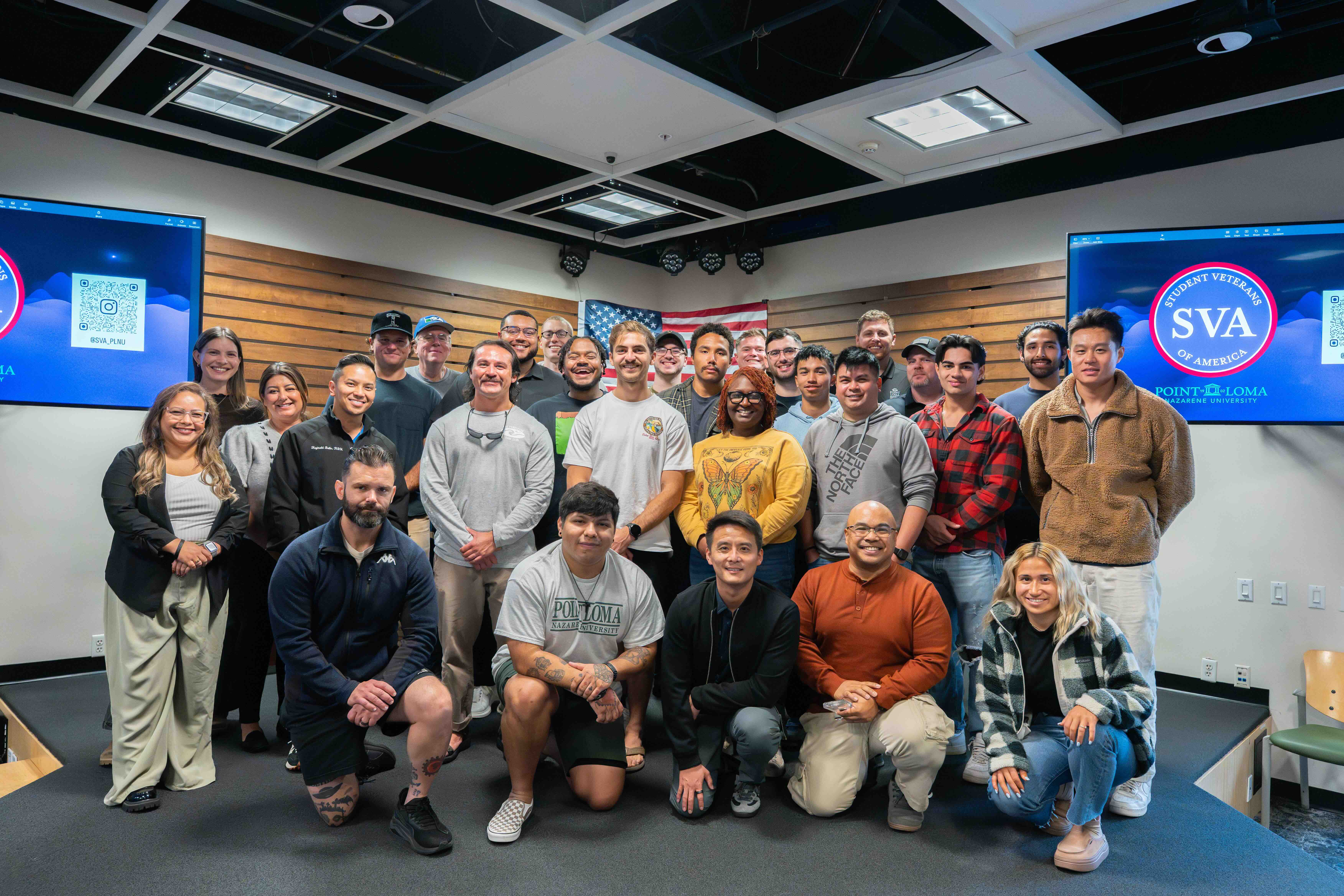 SVA members pose for a picture together in front of the SVA logo and the American flag at the 2026 Warrior's Breakfast.