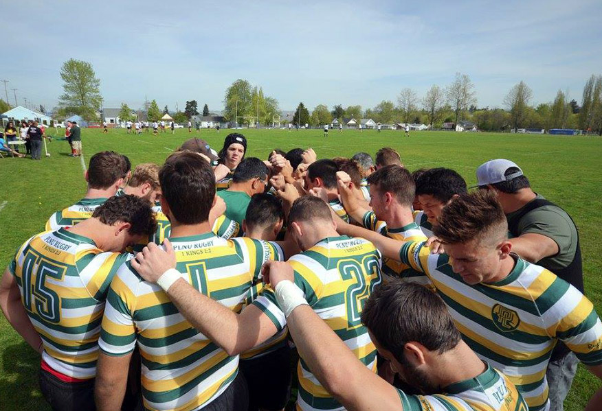 PLNU Rugby Club players gather in a huddle to pray before a match.