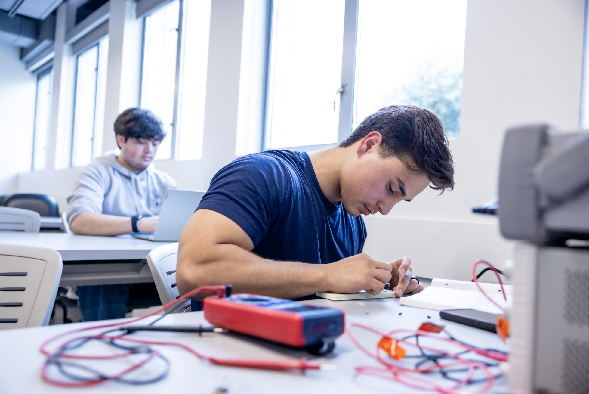 PLNU student works on technical project in the engineering lab.