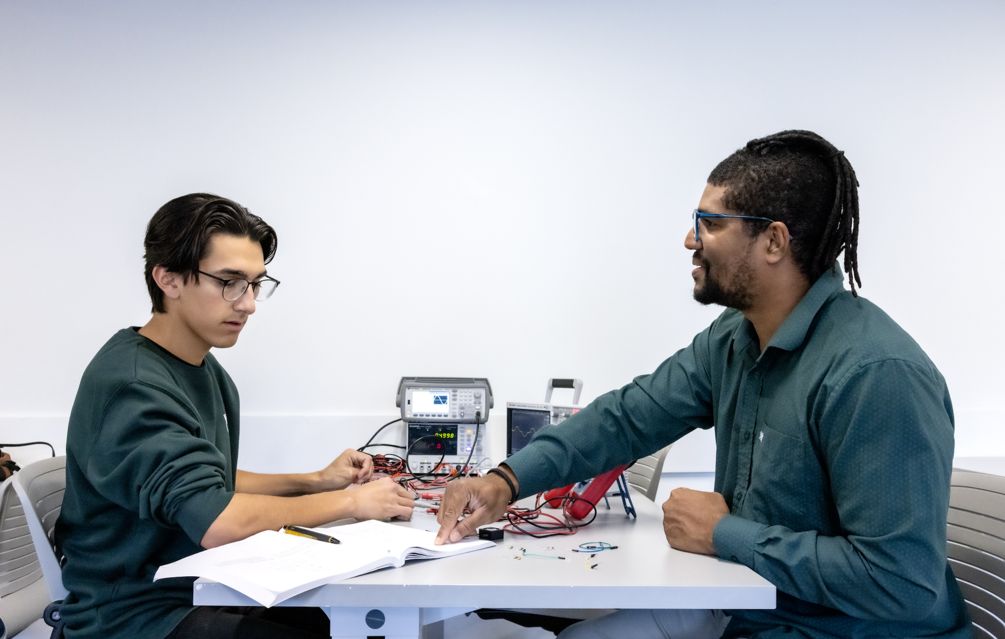 PLNU students work together on technical project in the engineering lab on the university campus.