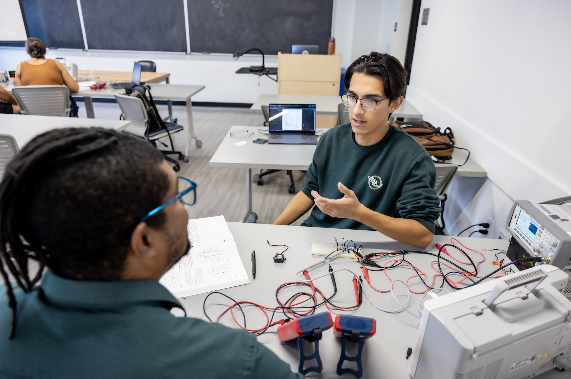 PLNU students work together on technical project in the engineering lab on the university campus.