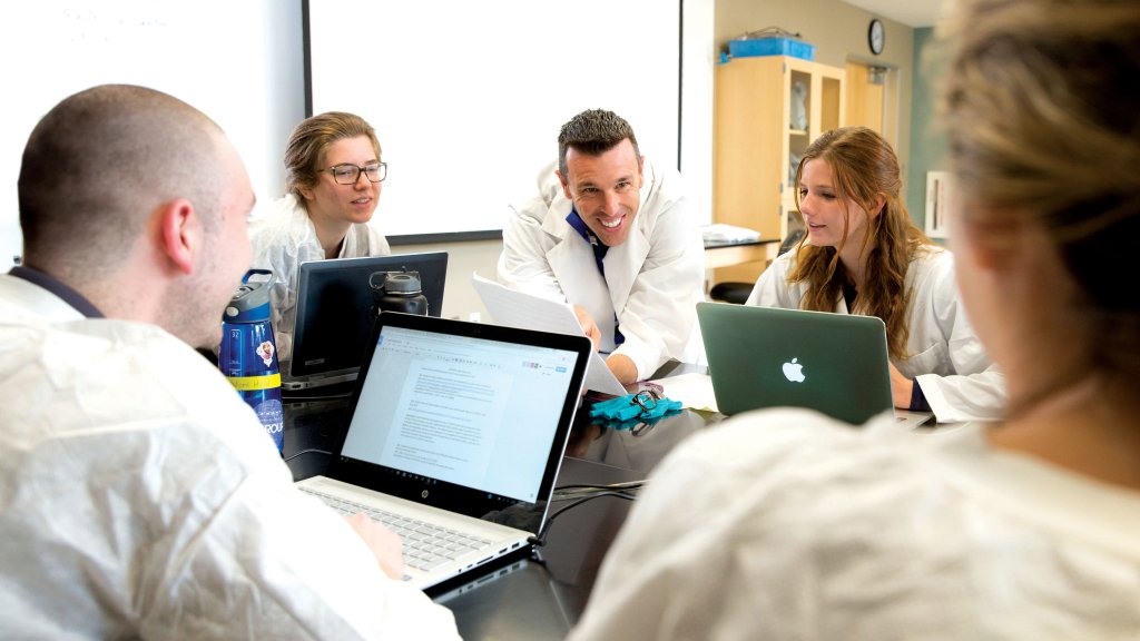 Undergraduate Biology students with professor during class