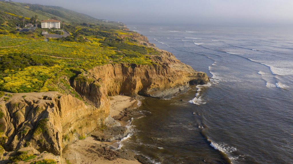 Aerial view overlooking Young Hall with the rugged coastline off the campus of PLNU