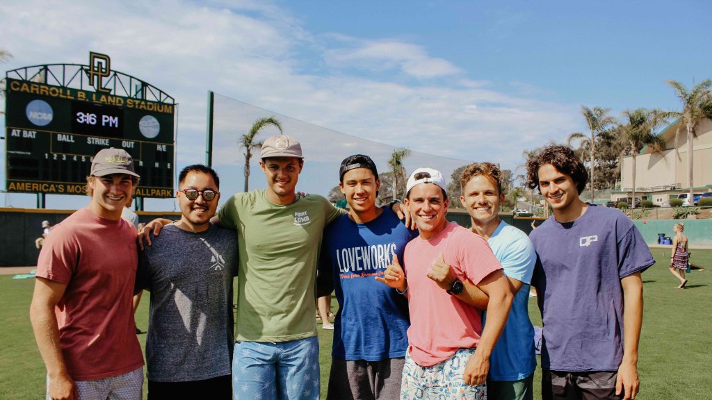 A group of male PLNU students pose for a photo outside 