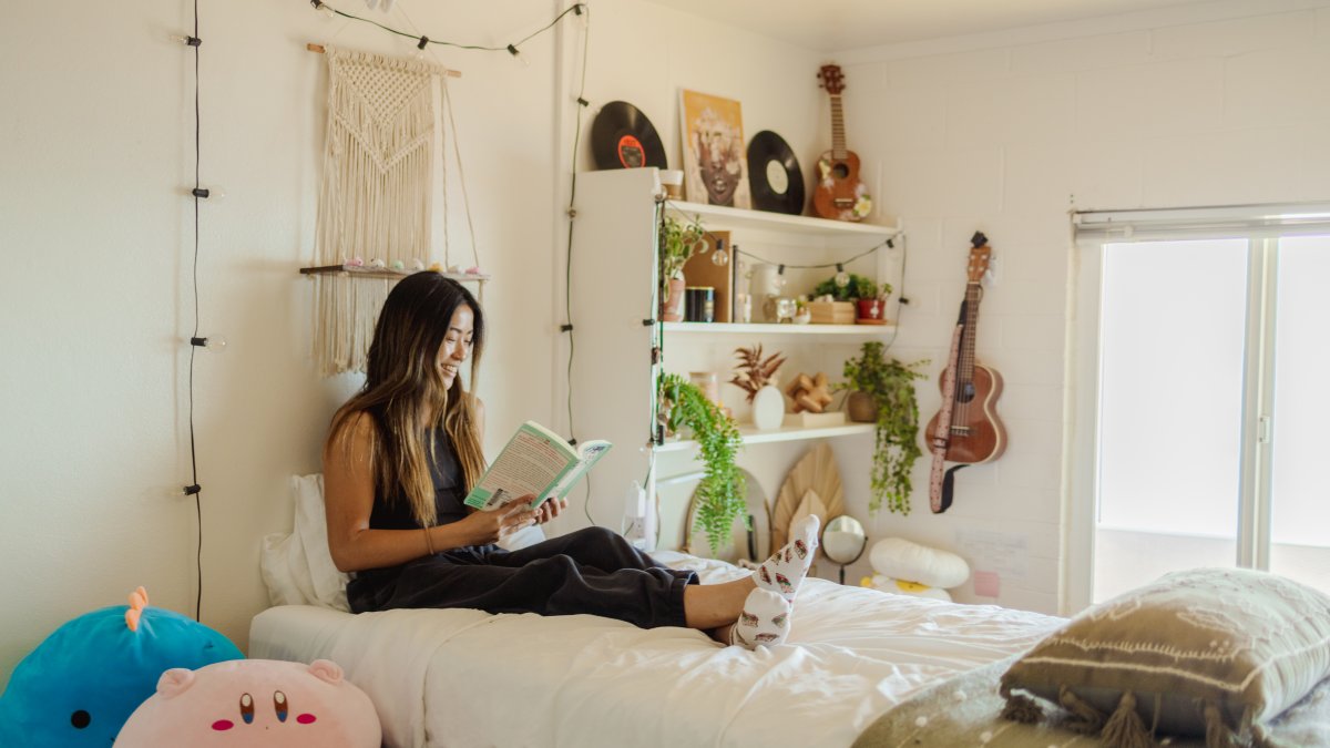 PLNU student reading a book in her Klassen Hall dorm room