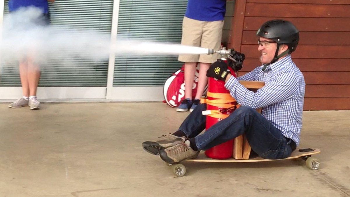 Myles Vandergrift pilots a fire extinguisher taped to a skateboard as part of a science experiment.