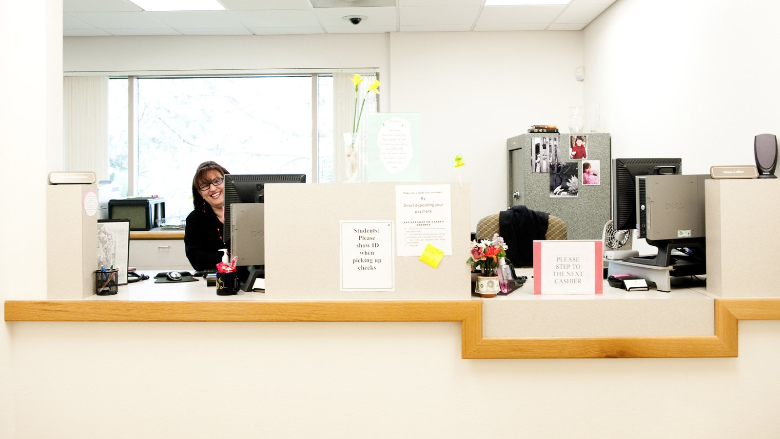 Support staff peaking around her computer in the accounting office