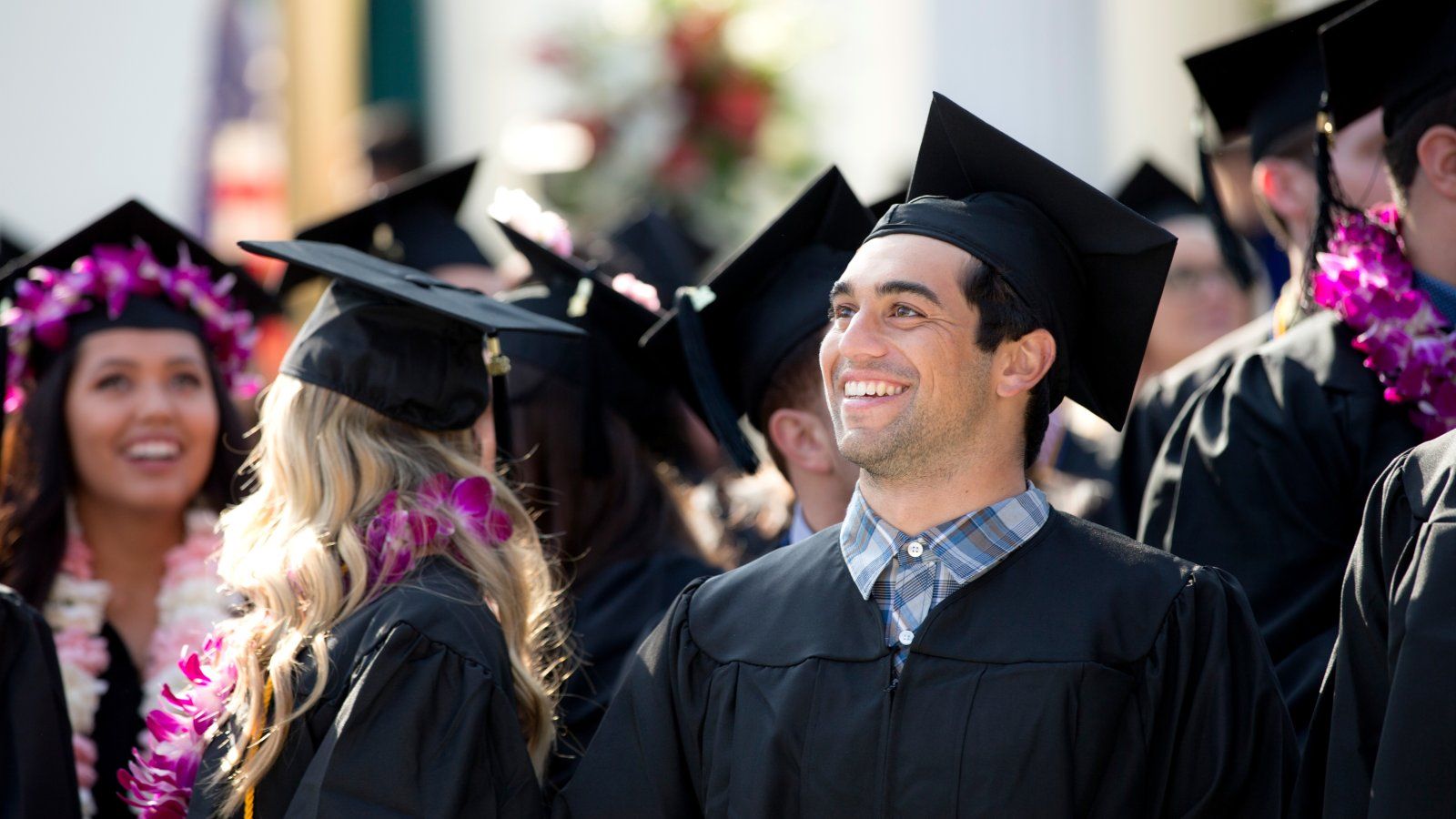 Male graduate student during commencement in crowd