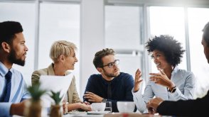 A group of workplace professionals have an informal meeting