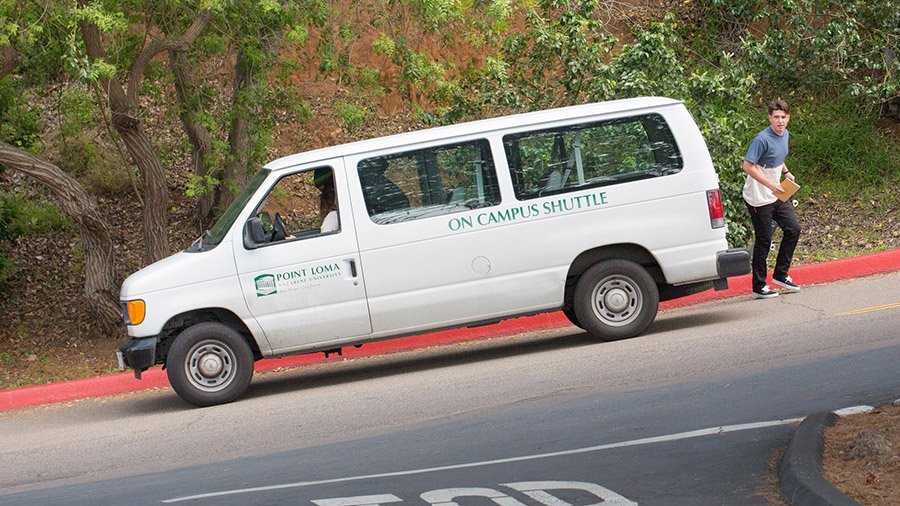 A student exits the on-campus shuttle to head to his dorm.