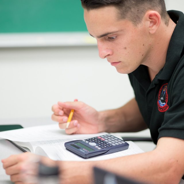 A student does classwork using a calculator.