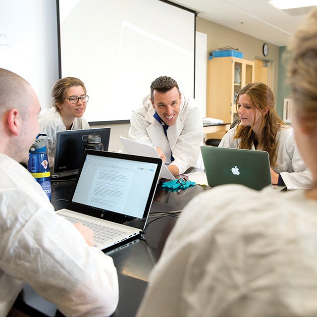 Dr. Mike Dorrell smiles as he works with students on a research project.