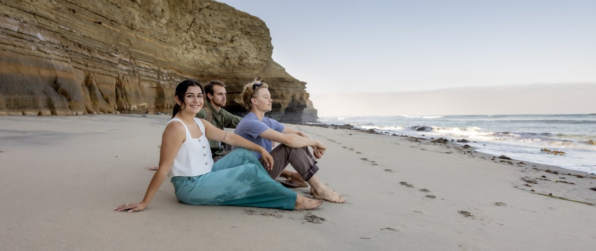 PLNU students posing on beach of Sunset Cliffs.