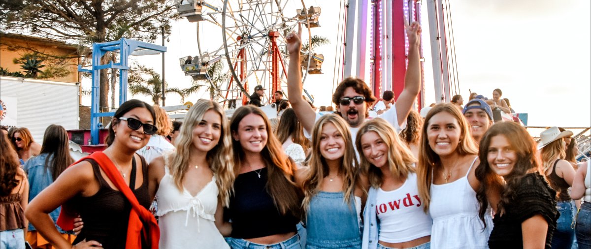 Group of friends in front of a Ferris Wheel