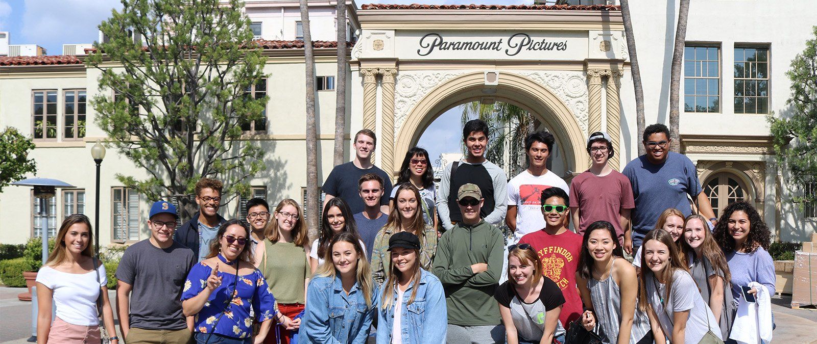 A media communication class poses for a photo in front of Paramount Studios during a class trip.