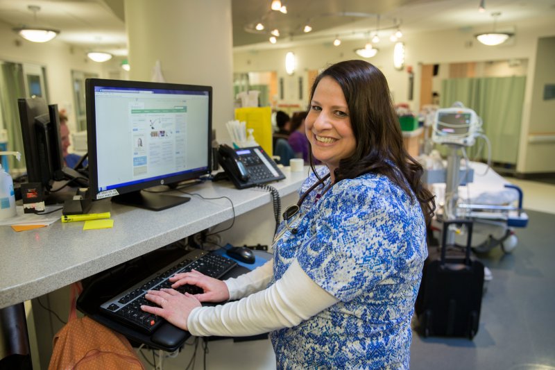 A nurse works on a computer in the hospital