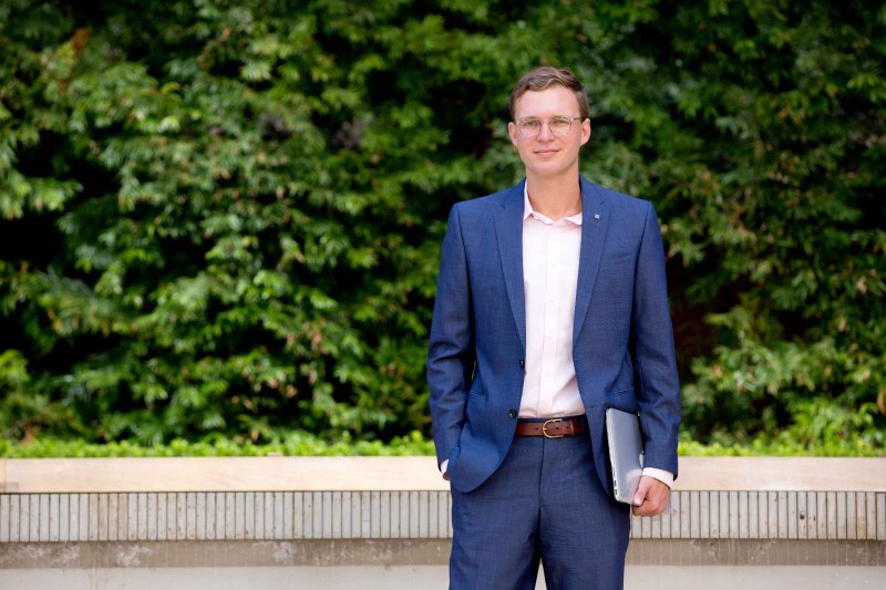 A business student smiles while outside in San Diego