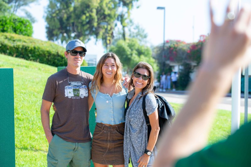 PLNU parents smile with their daughter 