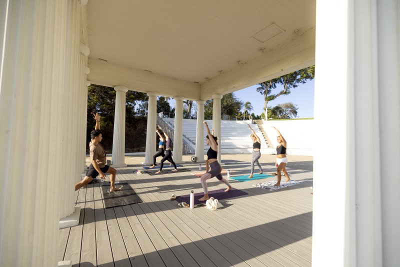 Six PLNU students practice yoga in the university's Greek Amphitheatre.