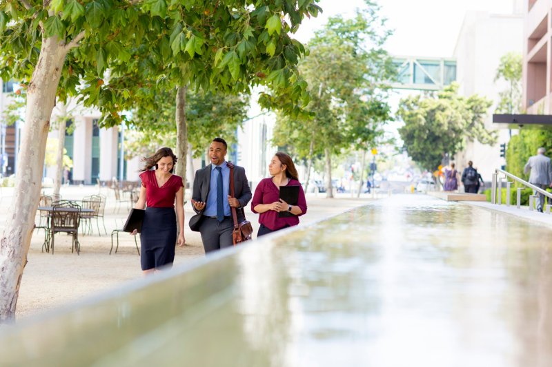 It is important to develop employees at every level within the company, pictured is a man walking with two colleagues. 