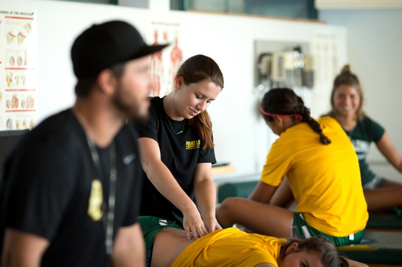 Kinesiology studen working on athlete