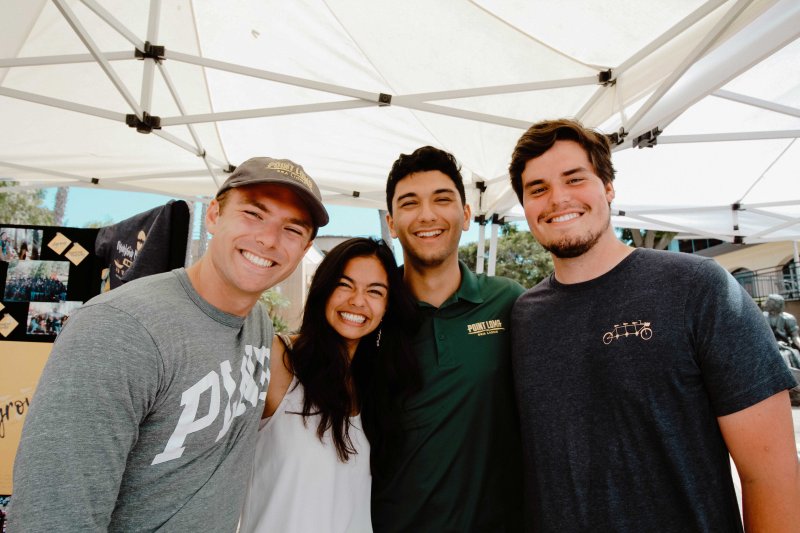 A group of students smile together