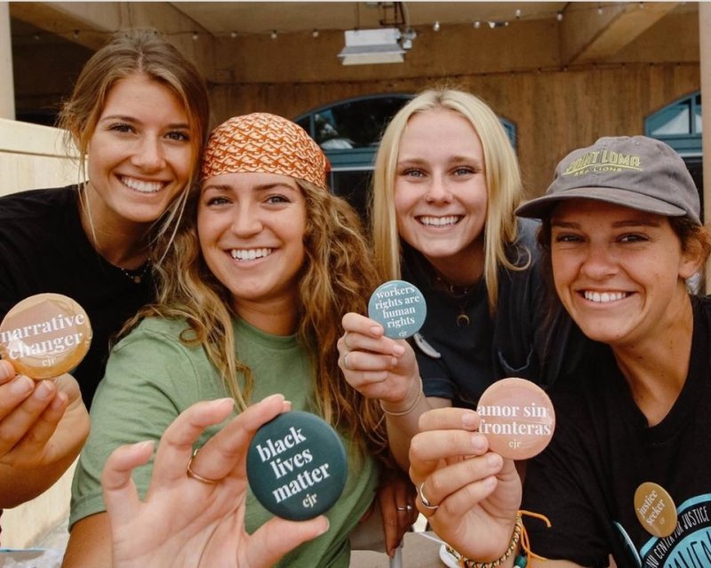 students holding buttons