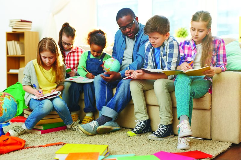 children reading with a teacher