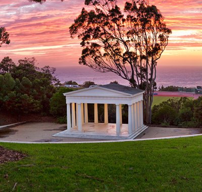 Orange and purple sunset in San Diego is framed by the iconic Greek Amphitheater on PLNU's campus