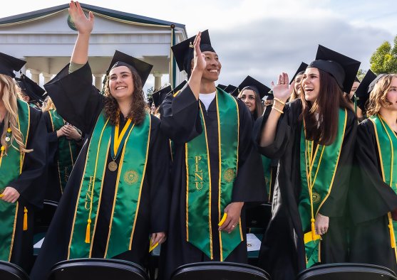 PLNU students dressed in regalia celebrating at their commencement.